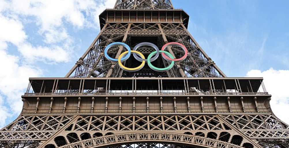 Photograph of the Olympic rings mounted on the Eiffel Tower.